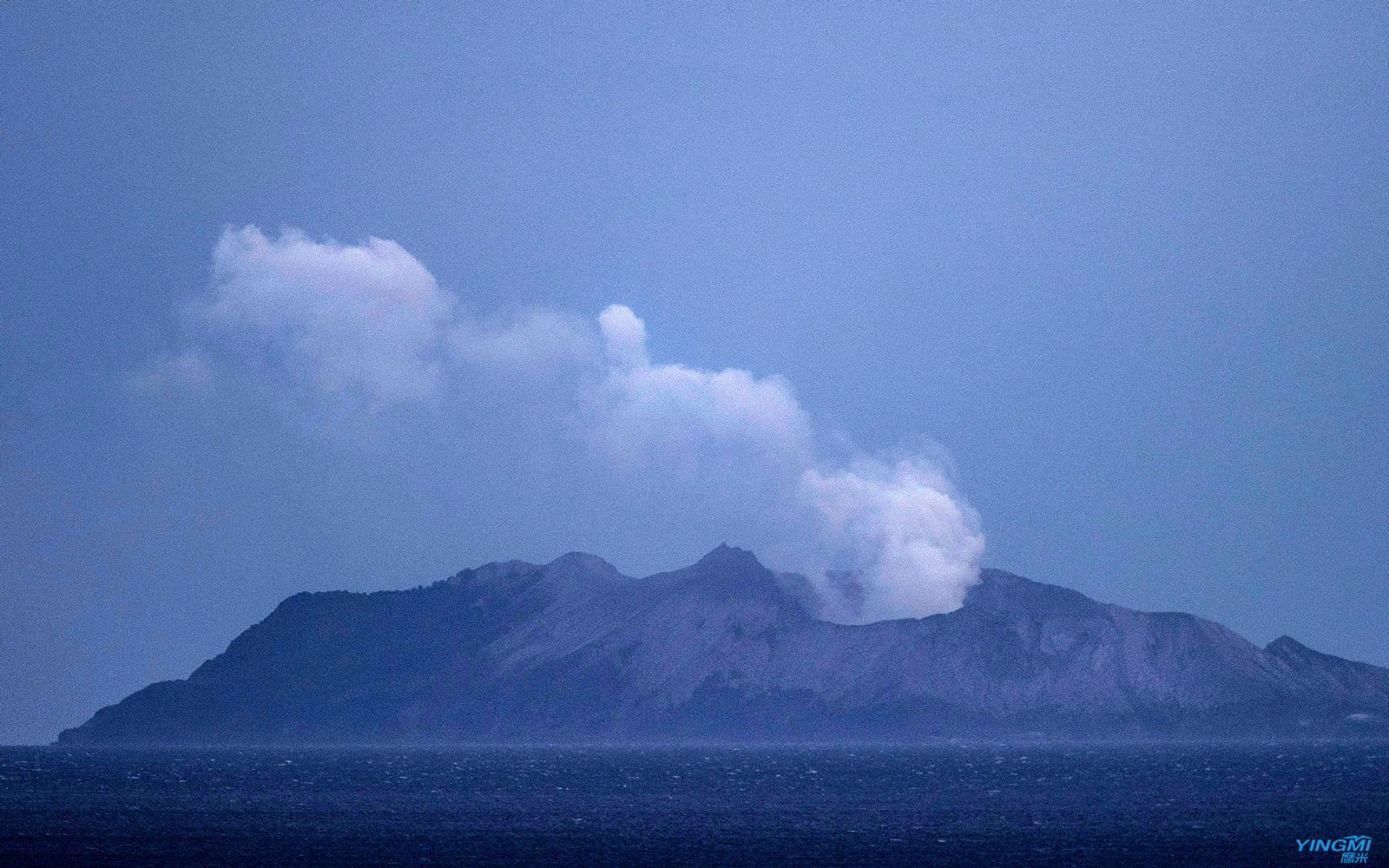 Smoke and ash rises from a volcano on White Island